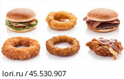 Creative food display featuring innovative fast food items shaped like popular snacks and meals. Стоковое AI-изображение, AI-художник Сергей Толмачёв / Фотобанк Лори