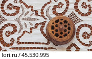 Video of beautiful white tablecloth with lace patterns embroidered in richelieu style or cutwork embroidery and old wooden box. Retro still life. Handicraft for home decoration. Close-up, flat lay. Стоковое видео, видеограф Виктория Катьянова / Фотобанк Лори