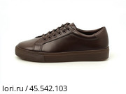 Dark brown leather lace-up running shoes with low tops, thick soles. The laces and black rubber outsole. Sporty look. Men to wear during outdoor activities, hiking. Brown shoes. Trendy Male Boots Pair. Стоковое AI-изображение, AI-художник Марина Демидюк / Фотобанк Лори