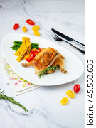 chicken thighs with corn, cherry tomatoes and herbs side view. Стоковое фото, фотограф Abakumova Ekaterina / Фотобанк Лори