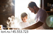 Joyful cooking moment between a father and son in a bright kitchen with steam rising from a pot. Стоковое AI-изображение, AI-художник Сергей Толмачёв / Фотобанк Лори