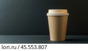 Blank brown coffee paper cup with white lid mockup. Disposable paper tea cup isolated on black. Togo Cup packaging for design, logo, text. Hygienic cooking or home delivery concept. Banner, template. Стоковое AI-изображение, AI-художник Марина Демидюк / Фотобанк Лори