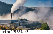 Geothermal power station emitting steam into the atmosphere in a mountainous landscape. Стоковое AI-видео, аниматор Юрий Поздников / Фотобанк Лори