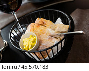 Sliced fresh baked artisan bread with butter in serving basket. Стоковое фото, фотограф Яков Филимонов / Фотобанк Лори