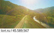 Low altitude flight over fresh fast mountain river with rocks at sunny summer morning. Стоковое видео, видеограф Александр Маркин / Фотобанк Лори
