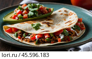Tacos filled with savory meat and crisp vegetables rest on a rustic platter surrounded by fresh limes, tomatoes, and salsa, showcasing vibrant Mexican cuisine. Стоковое AI-изображение, AI-художник Lena Bereberdina / Фотобанк Лори