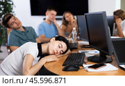 Young female developer tired after workday napping near computer. Стоковое фото, фотограф Яков Филимонов / Фотобанк Лори