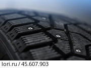 A brand new studded car tire with metal studs. Стоковое фото, фотограф EugeneSergeev / Фотобанк Лори