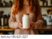 The girl advertises Biologically active additives, medicines. A white jar is in the young woman's hand. Стоковое AI-изображение, AI-художник Ирина Ручушкина / Фотобанк Лори