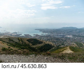 Panoramic view of Novorossiysk City and Tsemess Bay at sunrise. Morning cityscape of large port at Black Sea coast in Russia (2024 год). Стоковое фото, фотограф Фотограф / Фотобанк Лори