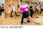 Middle-aged pair practicing ballroom dance in dance studio. Стоковое фото, фотограф Яков Филимонов / Фотобанк Лори