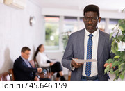 Upset middle-aged man standing with his back to waiting room. Стоковое фото, фотограф Яков Филимонов / Фотобанк Лори