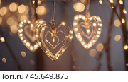 The concept of Valentine's Day, a banner with garlands in the form of hearts and magic lights for a holiday filled with love. A place for the text. Стоковое AI-изображение, AI-художник Photojuli / Фотобанк Лори