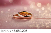 Gold wedding rings on a pink background with a side. Wedding rings. The wedding day. The newlyweds. Стоковое AI-изображение, AI-художник Photojuli / Фотобанк Лори