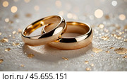 Gold wedding rings on a white background with a side. Wedding rings. The wedding day. The newlyweds. Стоковое AI-изображение, AI-художник Photojuli / Фотобанк Лори