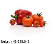 Tomatoes and red peppers on a white background. Стоковое фото, фотограф Ласточкин Евгений / Фотобанк Лори