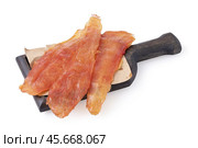 Chicken meat chips on a wooden board isolated on white background, sharpness across the object. Стоковое фото, фотограф Сергей Чайко / Фотобанк Лори