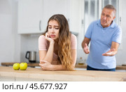 Elderly indignant father scolding adult daughter in kitchen. Стоковое фото, фотограф Яков Филимонов / Фотобанк Лори