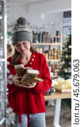 Teen girl selects suitable product from nougat assortment. Стоковое видео, видеограф Яков Филимонов / Фотобанк Лори