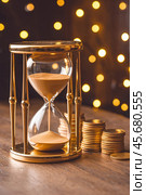Hourglass and columns of coins as a visualization of the aphorism Time is money. Стоковое AI-изображение, AI-художник Сергей Комаров / Фотобанк Лори