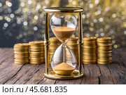 Hourglass and stacks of coins as an aphorism Time is money. Стоковое AI-изображение, AI-художник Сергей Комаров / Фотобанк Лори