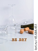 Dry January concept, empty glasses, bottles and corks on a gray background vertical view. Стоковое фото, фотограф Елена Руй / Фотобанк Лори