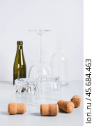 Alcoholism concept, empty glasses and bottles on grey background vertical view. Стоковое фото, фотограф Елена Руй / Фотобанк Лори