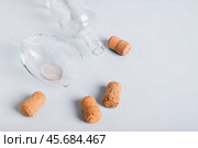 Refusal of alcohol, empty glass, bottle and corks on gray background. Стоковое фото, фотограф Елена Руй / Фотобанк Лори