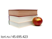Books and ripe apple on a white background. Стоковое фото, фотограф Ласточкин Евгений / Фотобанк Лори