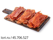 Three types of meat chips from pork, chicken and turkey on the board isolated on a white background, raw smoked snack to beer, sharpness across the object. Стоковое фото, фотограф Сергей Чайко / Фотобанк Лори