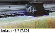 Modern Digital Large format UV printer. Printing production technologies. UV pinning is the process of applying a dose of low intensity ultraviolet light to a UV curable ink. Стоковое видео, видеограф Андрей Армягов / Фотобанк Лори