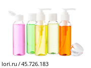 Variety of colorful personal care bottles and grooming accessories arranged on a white surface. Стоковое фото, фотограф Сергей Толмачёв / Фотобанк Лори