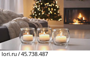 Candles and Soft Textile. Cozy Living Room Details. Flickering burning candle glasses, plush knit blanket. Atmosphere of serenity and comfort. Gray and brown color scheme. Modern boho house interior. Стоковое AI-видео, аниматор Марина Демидюк / Фотобанк Лори