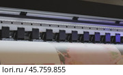 Modern Digital Large format UV printer. Printing production technologies. UV pinning is the process of applying a dose of low intensity ultraviolet light to a UV curable ink. Стоковое видео, видеограф Андрей Армягов / Фотобанк Лори