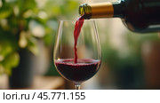 Pouring rich red wine into a glass against a vibrant green backdrop. Стоковое AI-изображение, AI-художник Сергей Толмачёв / Фотобанк Лори