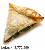Delicious triangular spanakopita pastry showing flaky crust and spinach filling. Стоковое AI-изображение, AI-художник Иван Рябоконь / Фотобанк Лори