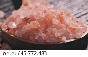 Himalayan pink salt in a wooden is used to flavor food. Due mainly to marketing costs, pink Himalayan salt is up to twenty times more expensive than table or sea salt. Стоковое видео, видеограф Андрей Армягов / Фотобанк Лори