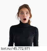 Shocked young woman opening her mouth in amazement. Стоковое AI-изображение, AI-художник Иван Рябоконь / Фотобанк Лори