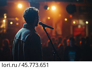 Performer stands near microphone under colorful lights at evening event. Стоковое AI-изображение, AI-художник Юлия Гапеенко / Фотобанк Лори