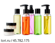 Variety of colorful personal care bottles and grooming accessories arranged on a white surface. Стоковое фото, фотограф Сергей Толмачёв / Фотобанк Лори
