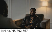 Rapper discussing with his manager in a modern apartment. Стоковое видео, видеограф Данил Руденко / Фотобанк Лори