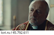 Senior Catholic Bishop Reflecting in Church. Стоковое видео, видеограф Данил Руденко / Фотобанк Лори