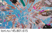Joyful high school students toss colorful confetti in the air to celebrate their summer graduation. Стоковое фото, фотограф Mikhail Davidovich / Фотобанк Лори