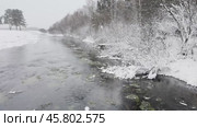 Video of winter landscape with non-freezing Oda River into which natural springs and sources flow. Snow-covered riverbank and forest. Winter travel and walks during New Year and Christmas holidays. Стоковое видео, видеограф Виктория Катьянова / Фотобанк Лори