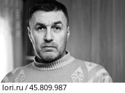 Portrait of a thoughtful and surprised middle-aged man in a wool sweater close-up black and white photo. Стоковое фото, фотограф Андрей С / Фотобанк Лори