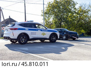 Maykop, Russia - October 22, 2024: a police car next to a wrecked car that was involved in an accident on a sunny autumn morning. Редакционное фото, фотограф Андрей С / Фотобанк Лори