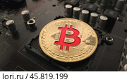 Gold Bit Coin BTC coins on the motherboard. Bitcoin is a worldwide cryptocurrency and digital payment system called the first decentralized digital currency. Стоковое видео, видеограф Андрей Армягов / Фотобанк Лори