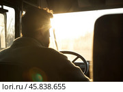 Driver turns steering wheel of truck, bus at sunset time. Skilled chauffeur drives lorry to deliver freight. Cargo shipping service. Drives Journey. Drivers silhouette against a vivid sundown. Travel. Стоковое AI-изображение, AI-художник Марина Демидюк / Фотобанк Лори