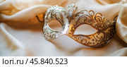 Venetian carnival mask resting on elegant silk drape. Стоковое AI-изображение, AI-художник Юрий Поздников / Фотобанк Лори