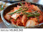 Kimchi fermented napa cabbage with gochugaru, garlic, ginger, and sesame seeds. Стоковое AI-изображение, AI-художник Иван Рябоконь / Фотобанк Лори
